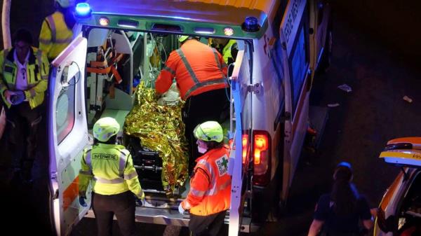 Emergency respo<em></em>nders tend to a person in the back of an ambulance. 