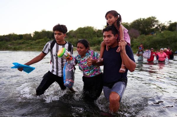 A family crossing through the Rio Grande from Mexico last Friday. 
