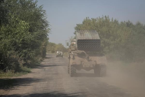 Ukrainian servicemen ride in a BM-21 Grad multiple launch rocket system near a front line in August.