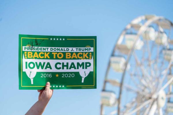 An attendee holds a sign as former US President Do<em></em>nald Trump attends the Iowa State Fair in Des Moines, Iowa.